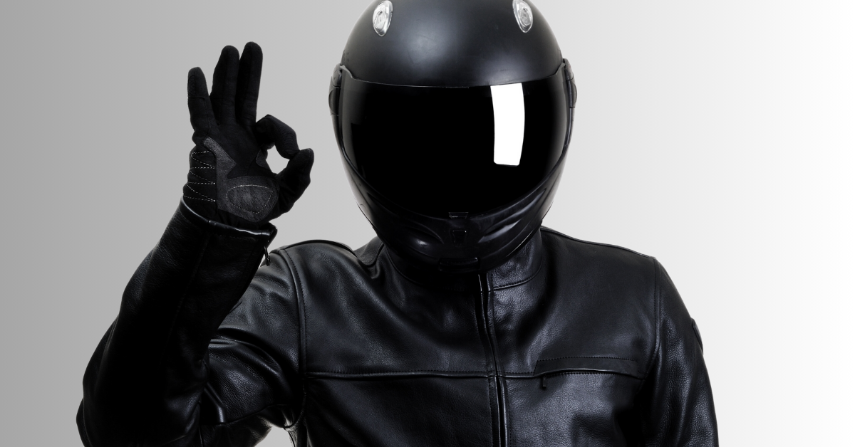 Motorcyclist dressed in all black with safety helmet